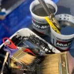 A photograph of various art supplies, tools, and ink on a table at Dr. Sobo's gestural art therapy workshop.