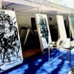 A series of completed gestural art therapy canvases with black ink on white paper.